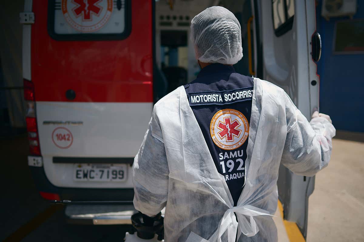 Brazilian medical worker closes the door of an ambulance in Araraquara, Sao Paulo