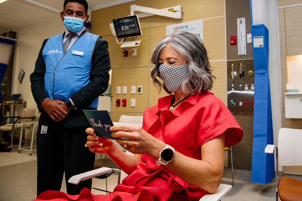 Chief Public Health Officer Nicola Spurrier holds a thank-you card after being vaccinated in Adelaide, Australia