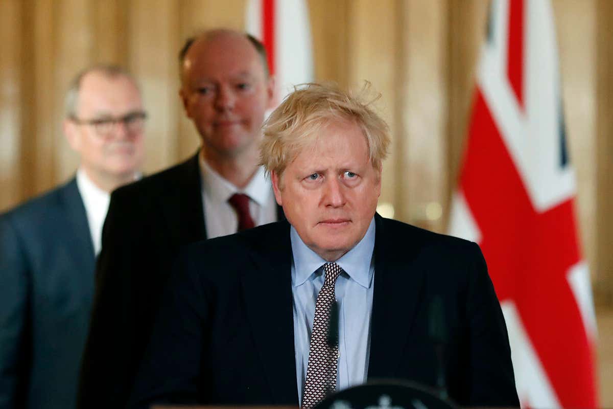 UK Prime Minister Boris Johnson arrives for a press conference with Chief Medical Officer Chris Whitty, and Chief Scientific Adviser Patrick Vallance