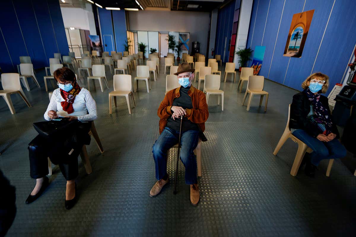 People wait in a vaccination centre in Nice, France