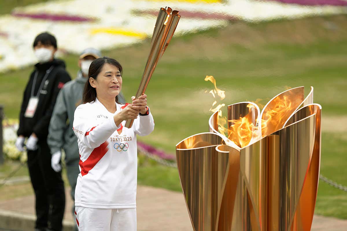 Virus Outbreak Tokyo Olympics, Suita, Japan - 14 Apr 2021 The last Olympic torch relay runner for the Osaka leg concludes the event in Suita, north of Osaka, western Japan