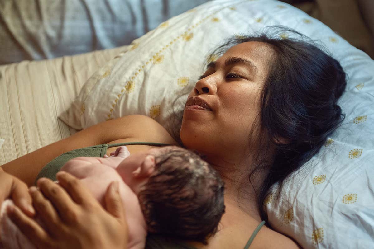 A women holds her newborn baby after a home birth