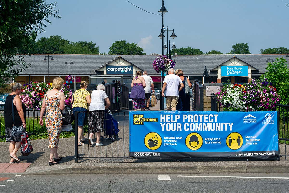 people walking to a shopping centre