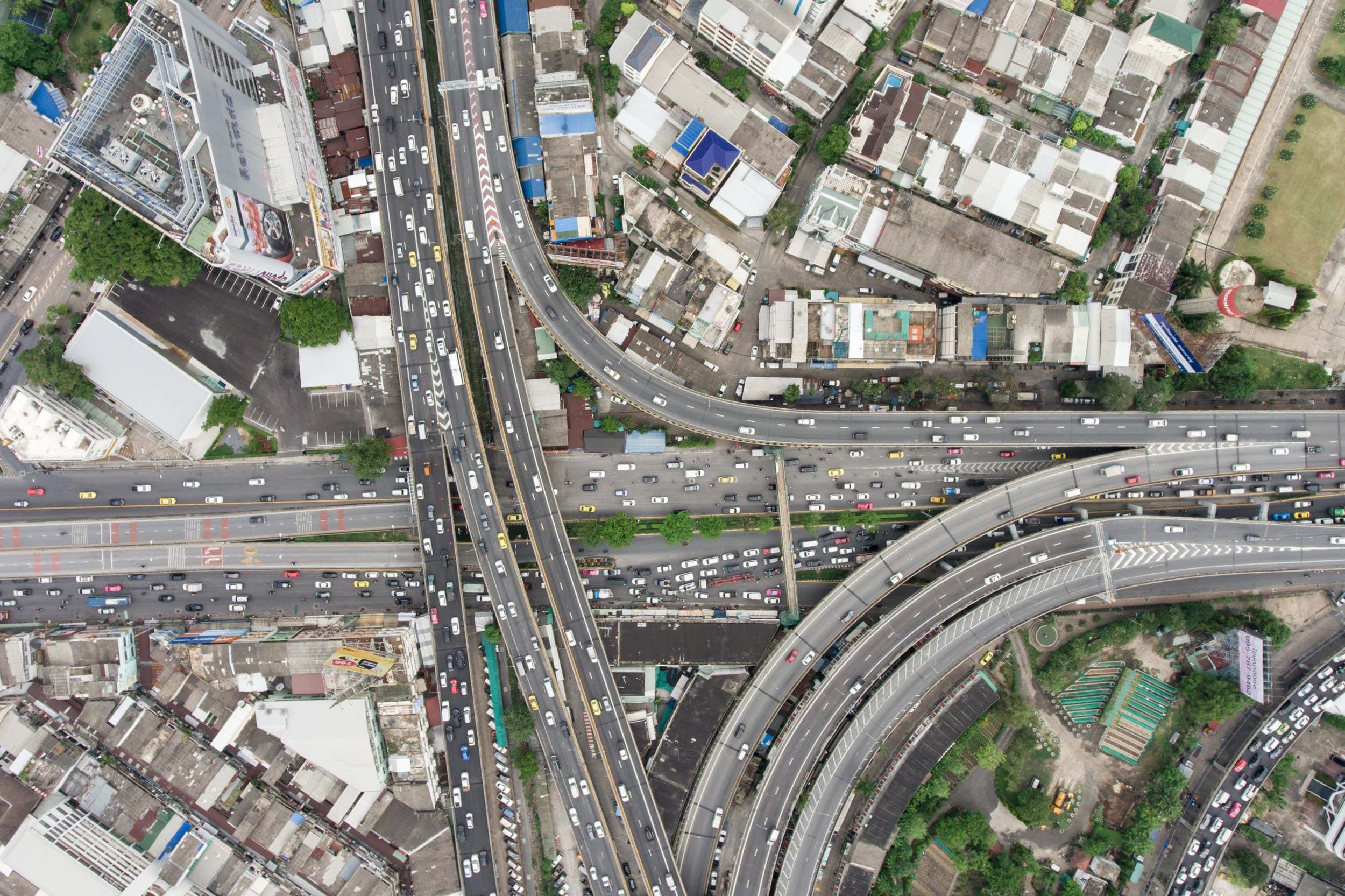 Aerial view of traffic jam in urban city. Top down view from up high. Afternoon day light shot. Congestion and urban life concept.