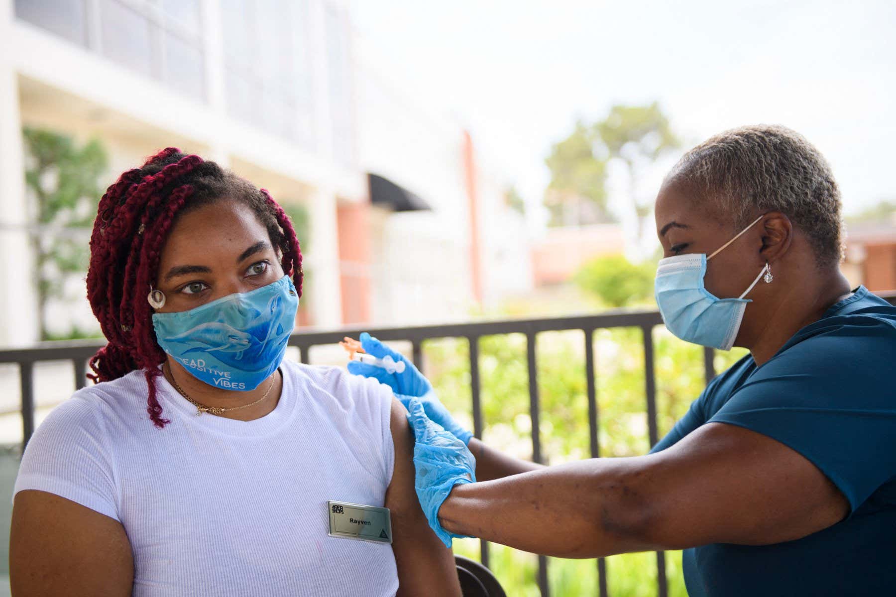 A nurse administers a dose of the Pfizer Covid-19 vaccine to a college student during a City of Long Beach Public Health Covid-19 mobile vaccination clinic at the California State University Long Beach (CSULB) campus on August 11, 2021 in Long Beach, California. - Students, staff, and faculty at the California State University (CSU) and University of California (UC) system schools will be required to be fully vaccinated in order to attend in-person classes. All teachers in California will have to be vaccinated against Covid-19 or submit to weekly virus tests, the state's governor announced June 11, as authorities grapple with exploding infection rates. (Photo by Patrick T. FALLON / AFP) (Photo by PATRICK T. FALLON/AFP via Getty Images)