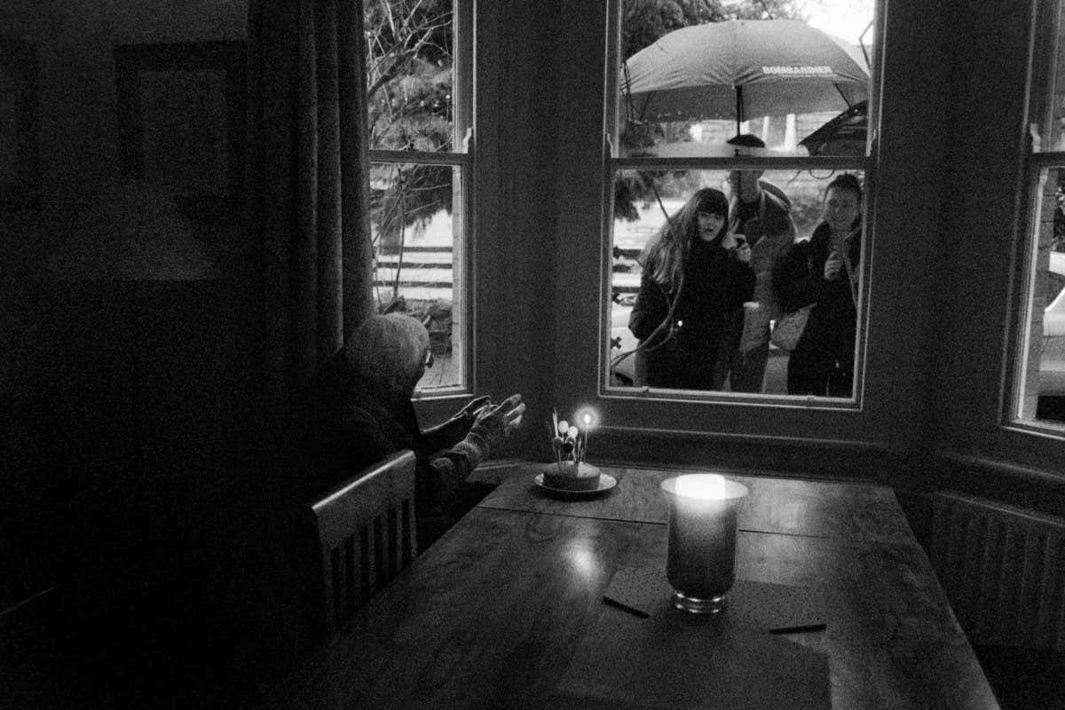 WINNER Hugh conducts as three of his grandchildren sing him 'happy birthday' in the rain.