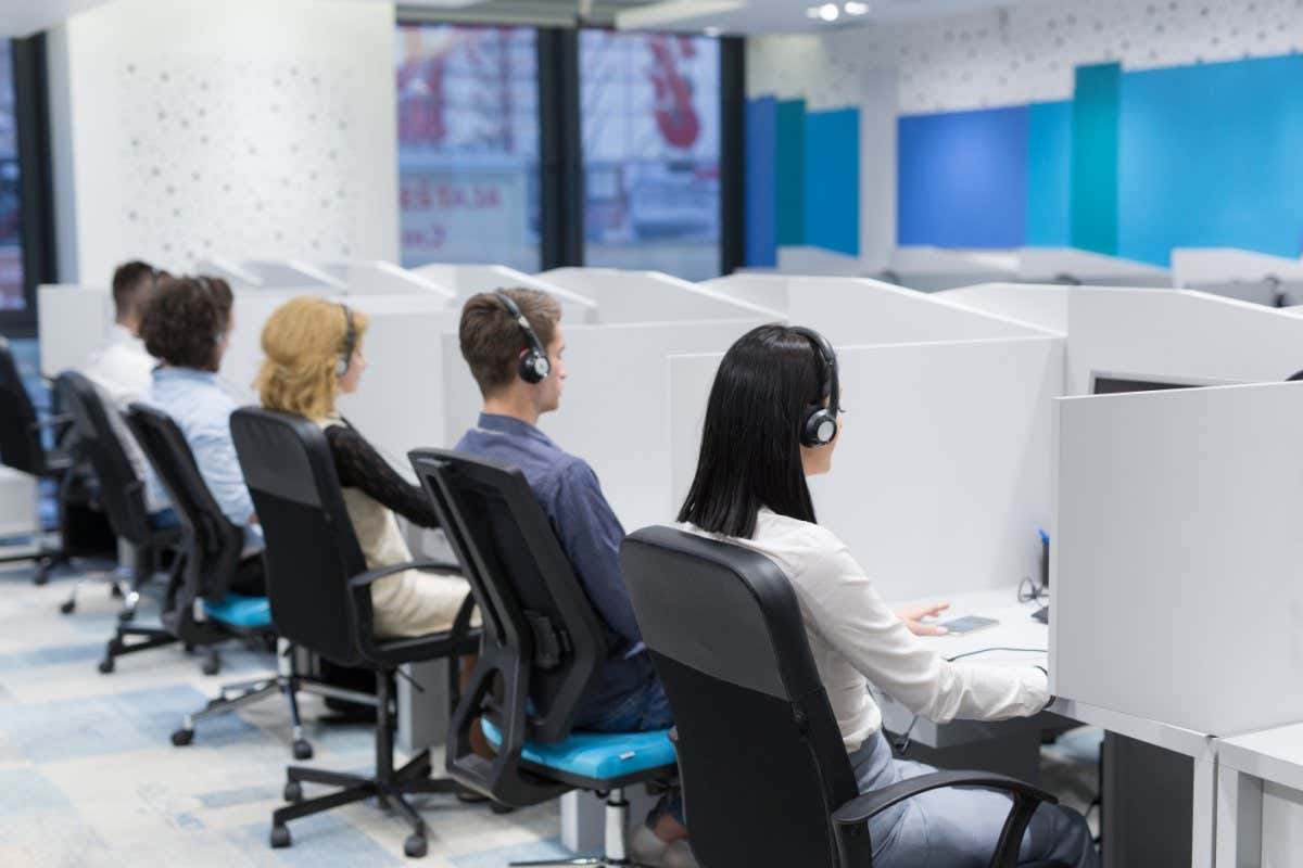 group of young business people with headset working and giving support to customers in a call center office; Shutterstock ID 703597705; purchase_order: -; job: -; client: -; other: -