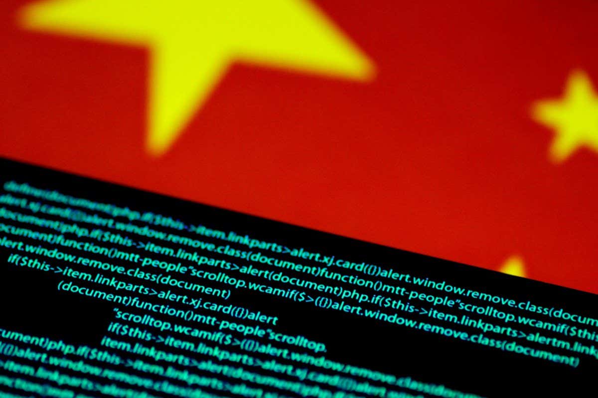 2CRH8C5 Computer code is seen on a screen above a Chinese flag in this July 12, 2017 illustration photo. REUTERS/Thomas White/Illustration