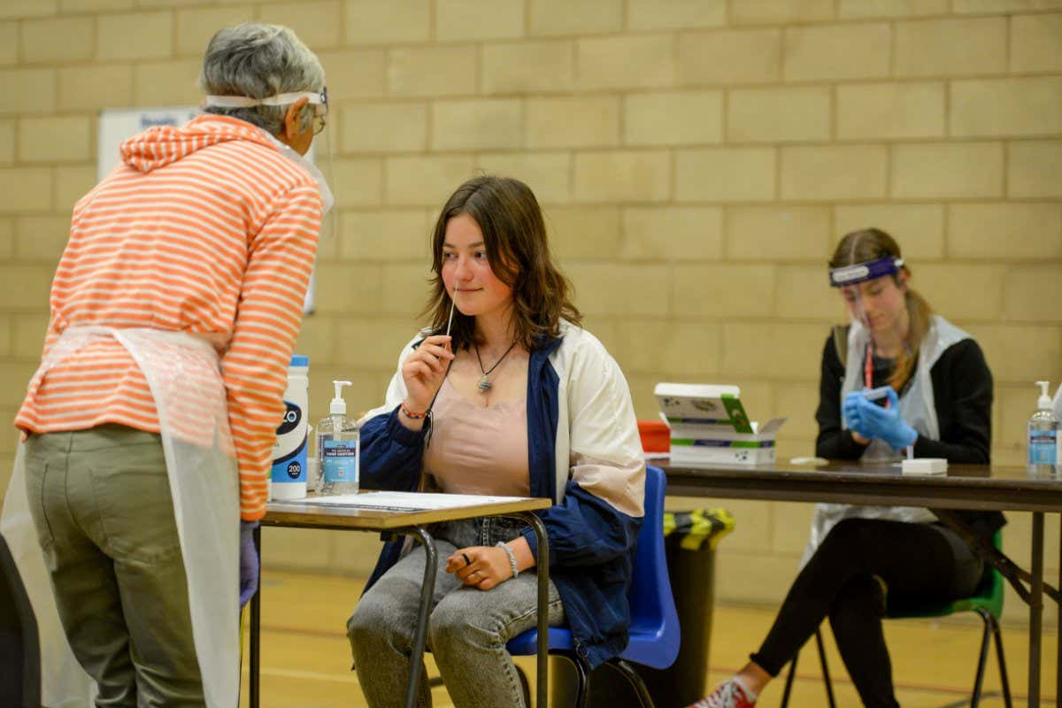 WEYMOUTH, ENGLAND - SEPTEMBER 03: Year 11 pupils get tested prior to returning to school next week at The Wey Valley Academy on September 03, 2021 in Weymouth, England. Covid-19 testing stations are being installed in schools across England rather than allowing pupils to take lateral flow tests at home in efforts to better detect cases before they become outbreaks. (Photo by Finnbarr Webster/Getty Images)