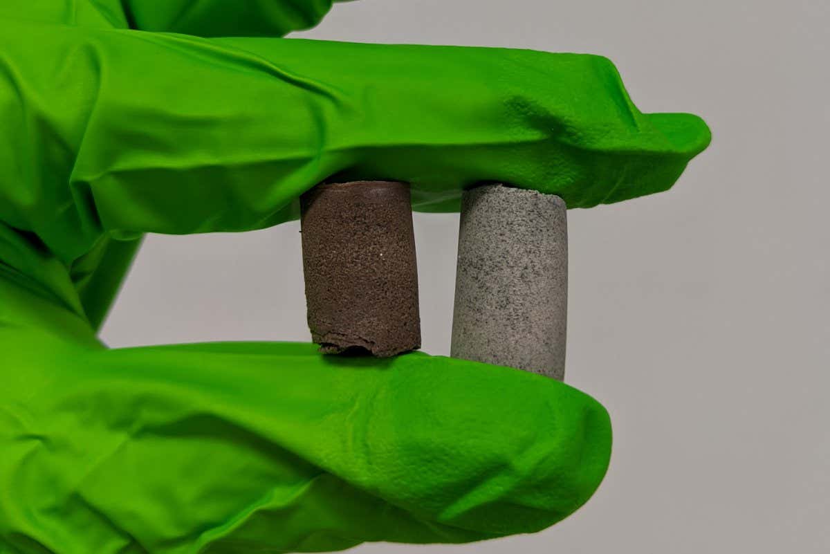 A gloved hand holds samples of Astrocrete