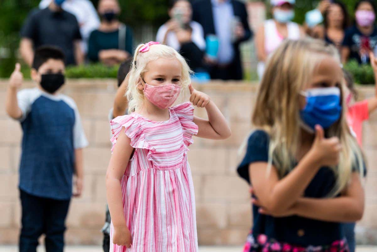 Laguna Niguel, CA - August 17: A kindergarten student gives the thumbs up to her teacher before starting the first day of kindergarten at Laguna Niguel Elementary School in Laguna Niguel, CA on Tuesday, August 17, 2021. (Photo by Paul Bersebach, MediaNews Group/Orange County Register via Getty Images)