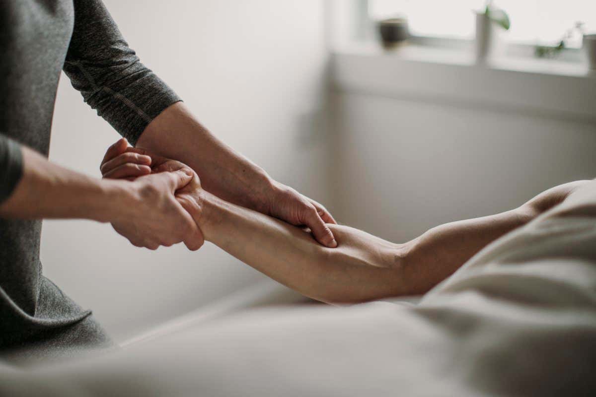 Person massages another person's arm