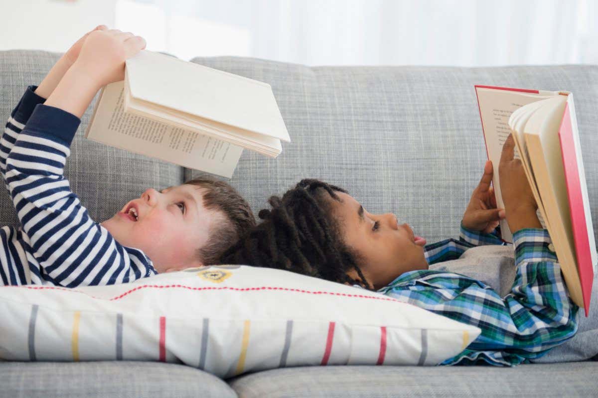 Boys reading on living room sofa