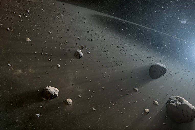 Artist's illustration of an asteroid belt, with rocks against dark space lit from the side.