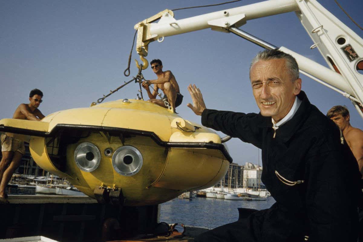 Underwater pioneer Jacques Cousteau guides his latest underwater research vessel for an expedition to study the Caribbean's teeming sea life. National Geographic sponsored the expedition. (Thomas J. Abercrombie/National Geographic)
