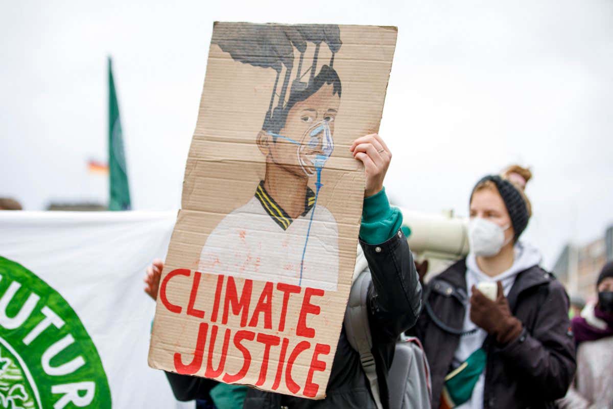 People take part in the ''Friday For Future'' demonstration, in Berlin, Germany, on October 22, 2021. (Photo by Achille Abboud/NurPhoto via Getty Images)