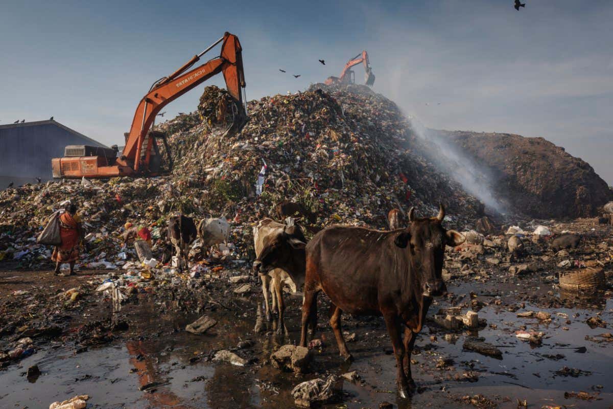 Methane seeps from waste at a dumping zone in Belgharia, India.