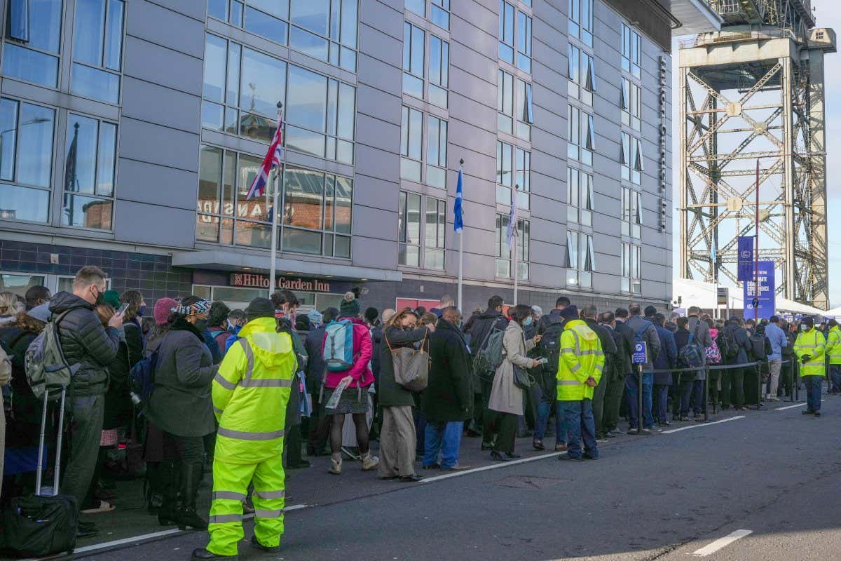 Delegates queuing to get into the COP26 climate meeting in Glasgow yesterday