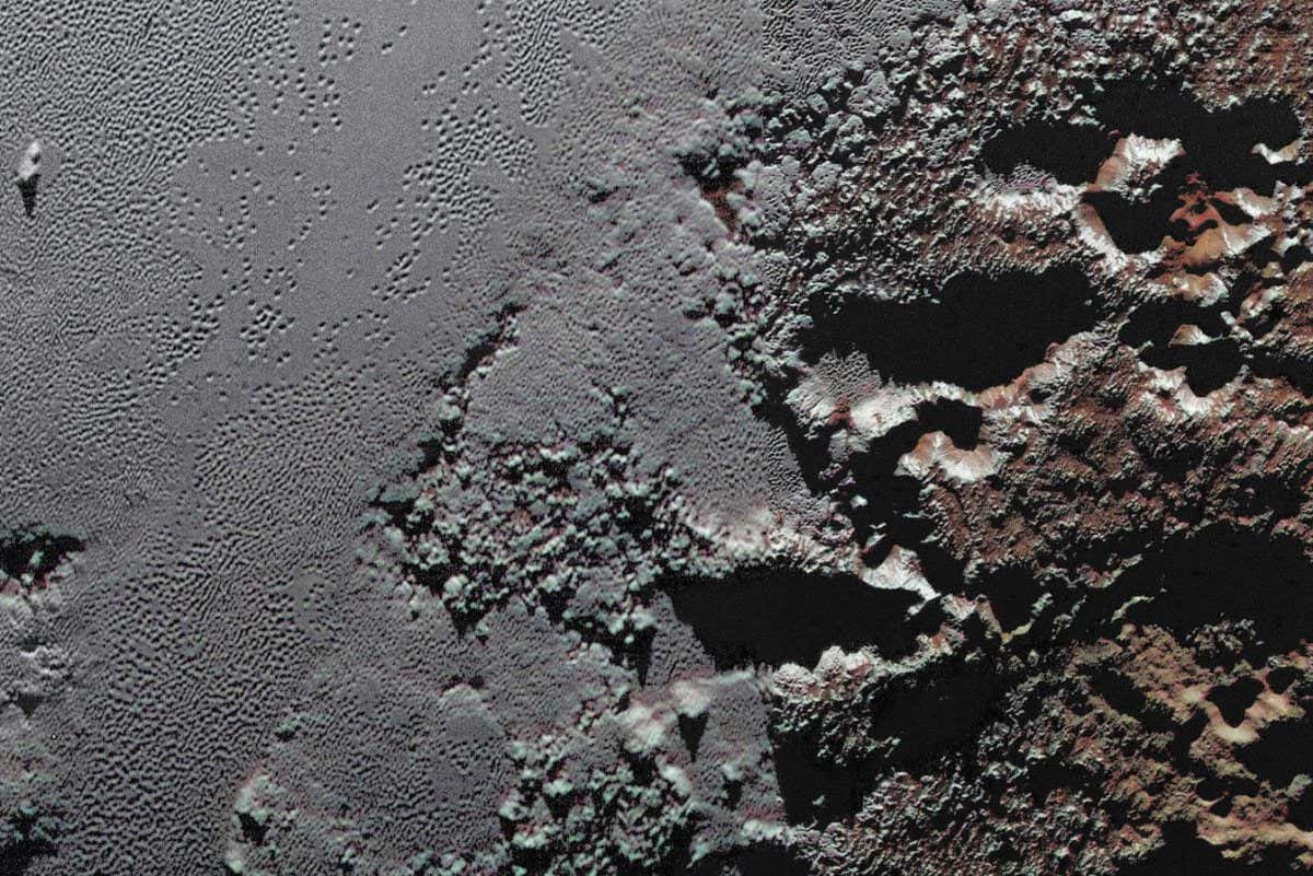 This enhanced color view from NASA's New Horizons spacecraft zooms in on the southeastern portion of Pluto's great ice plains, where at lower right the plains border rugged, dark highlands informally named Krun Macula.