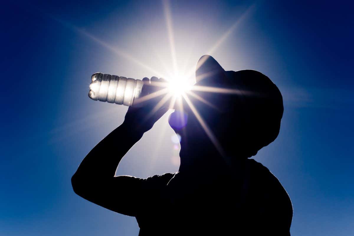 young boy drinks water