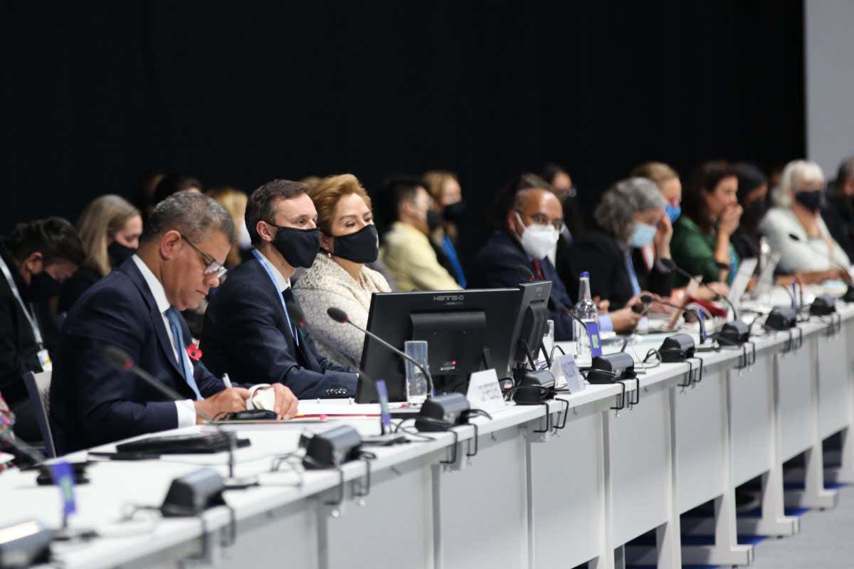 UN climate chief Patricia Espinosa sits among other COP26 delegates.