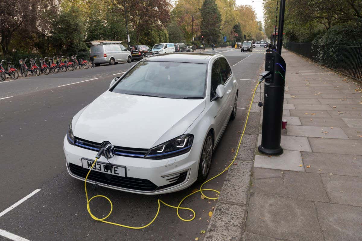 Electric car charging in street, London, England, UK