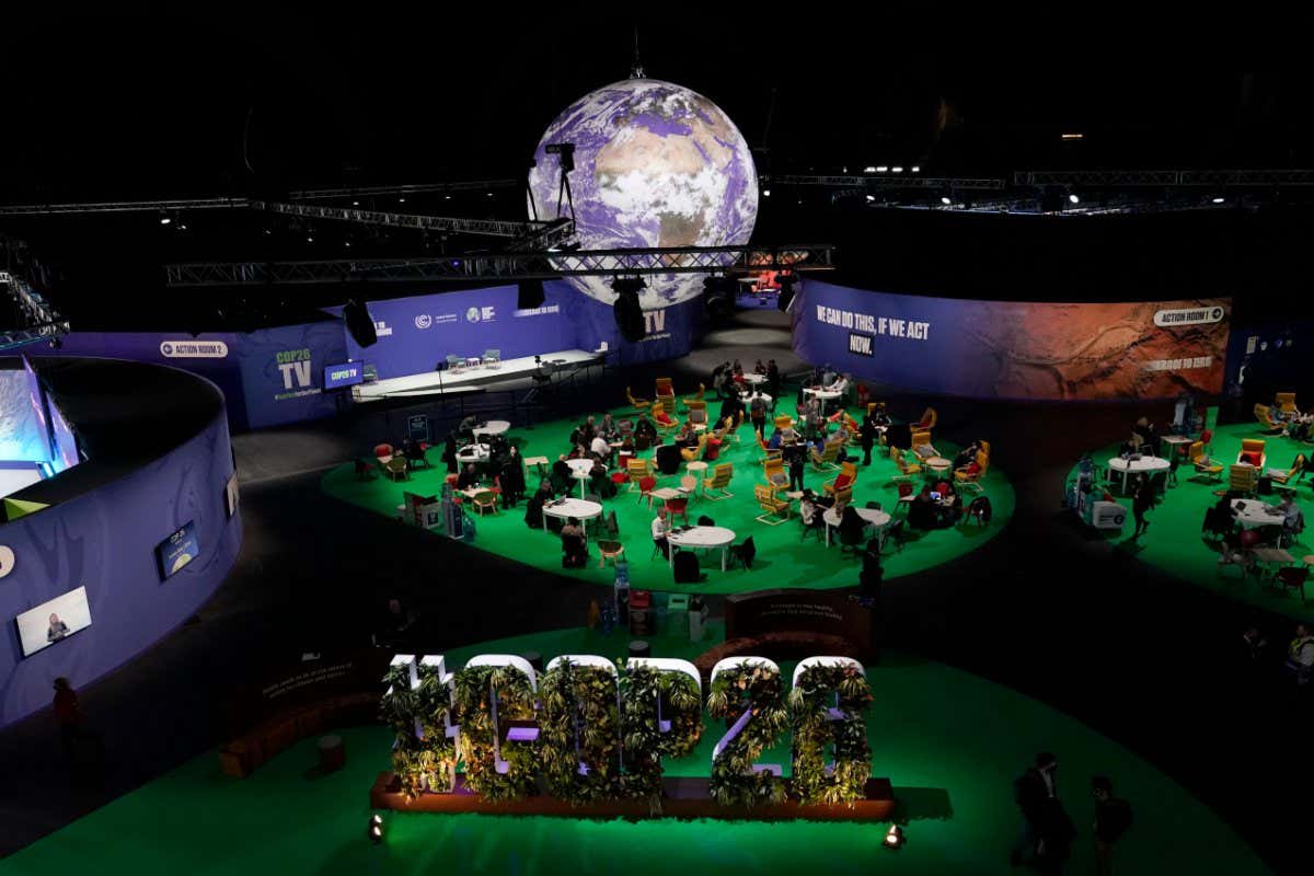 Mandatory Credit: Photo by Alberto Pezzali/AP/Shutterstock (12593497a) People gather in the Action Zone inside the venue for the COP26 U.N. Climate Summit in Glasgow, Scotland, . The U.N. climate summit in Glasgow is entering it's second week as leaders from around the world, are gathering in Scotland's biggest city, to lay out their vision for addressing the common challenge of global warming Climate COP26 Summit, Glasgow, United Kingdom - 08 Nov 2021