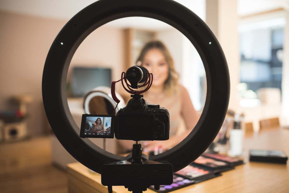 A young woman vlogging herself doing makeup