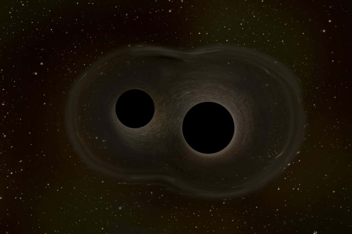 This artistic impression shows two black holes that are spiralling towards each other and will eventually coalesce.