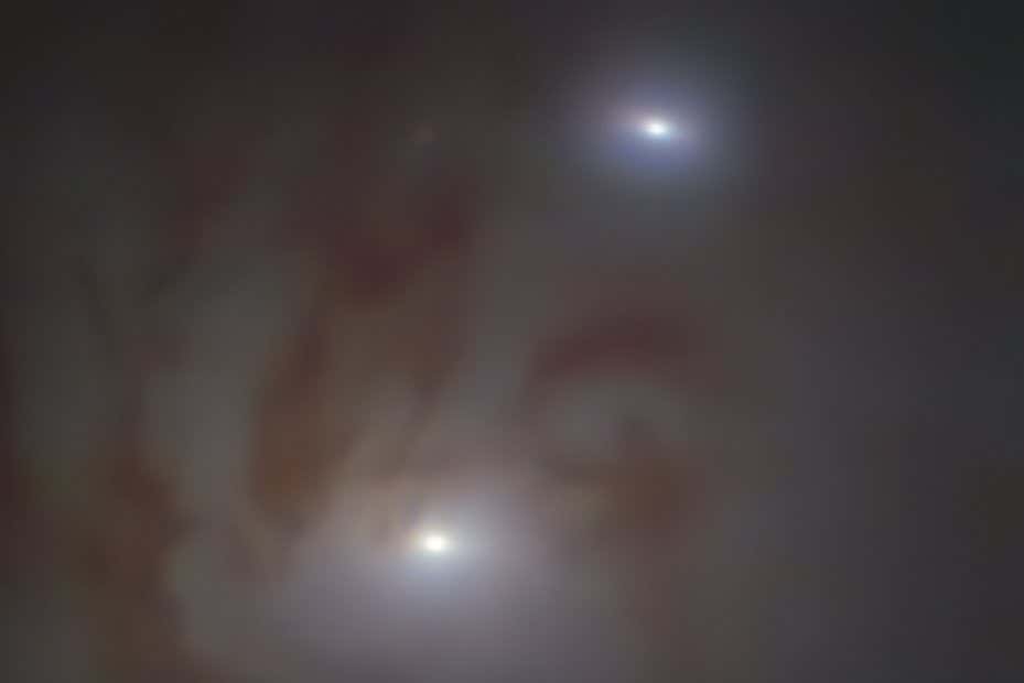 Close-up view of the two bright galactic nuclei, each housing a supermassive black hole, in NGC 7727, a galaxy located 89 million light-years away from Earth in the constellation Aquarius. Each nucleus consists of a dense group of stars with a supermassive black hole at its centre. The two black holes are on a collision course and form the closest pair of supermassive black holes found to date. It is also the pair with the smallest separation between two supermassive black holes ??? observed just 1600 light-years apart in the sky.???? The image was taken with the MUSE instrument on ESO???s Very Large Telescope (VLT) at the Paranal Observatory in Chile.
