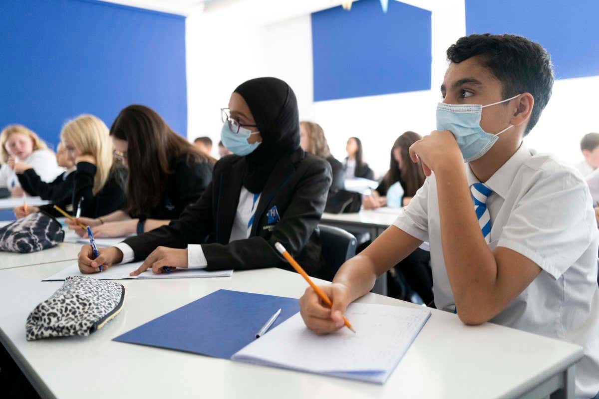 CARDIFF, WALES - SEPTEMBER 20: Children wear face masks during a maths lesson at Llanishen High School on September 20, 2021 in Cardiff, Wales. All children aged 12 to 15 across the UK will be offered a dose of the Pfizer-BioNTech Covid-19 vaccine. Parental consent will be sought for the schools-based vaccination programme. (Photo by Matthew Horwood/Getty Images)