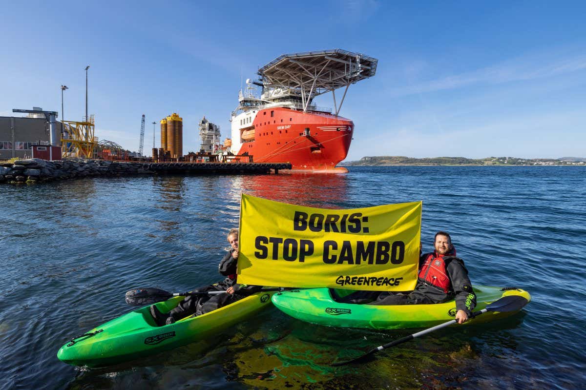 Greenpeace Norway activists in kayaks confront Siem Day loading drilling infrastructure for the Cambo oil field on behalf of Siccar Point Energy and Shell Oil, at Randaberg Industries, outside Stavanger, Norway.
