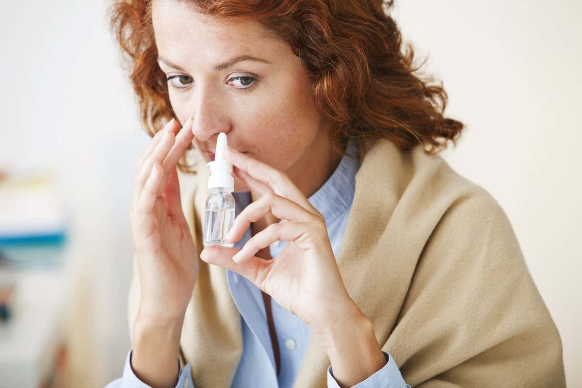 Woman Using Nose Spray; Shutterstock ID 173816945; purchase_order: -; job: -; client: -; other: -