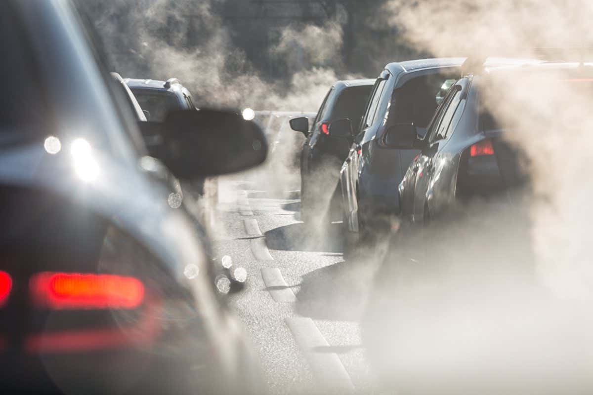 Cars in a traffic jam surrounded by steam from their exhaust pipes