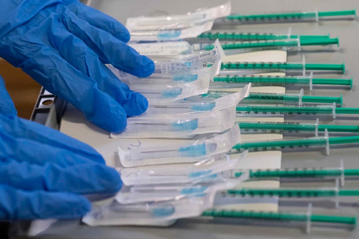 Syringes filled with the BioNtech-Pfizer Covid-19 coronavirus vaccine are being prepared in a mobile vaccination center in Hemmingen near Ludwigsburg, southern German. (Photo by THOMAS KIENZLE / AFP) (Photo by THOMAS KIENZLE/AFP via Getty Images)