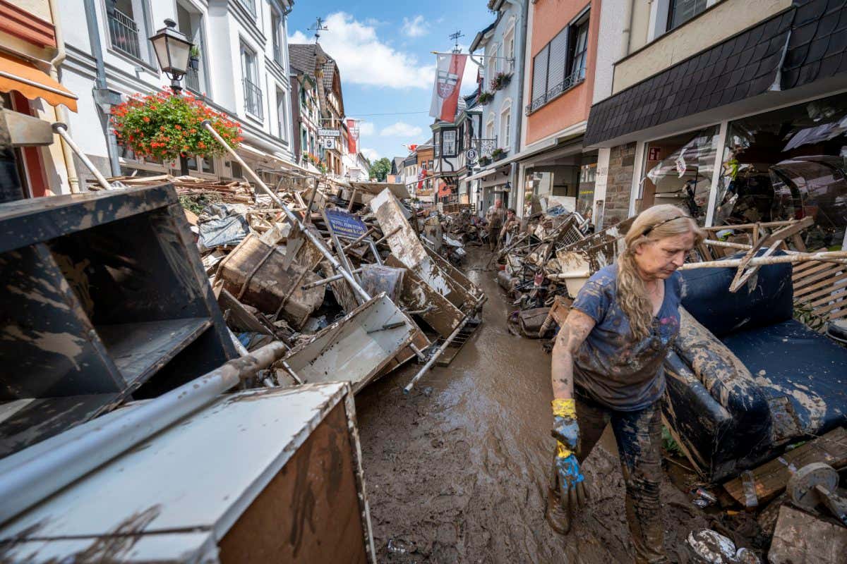 BAD NEUENAHR, GERMANY - JULY 18: Volunteers and residents start the clean up process at their shops and restaurants following severe flash flooding on July 18, 2021 in Bad Neuenahr-Ahrweiler, Germany. (Photo by Thomas Lohnes/Getty Images)