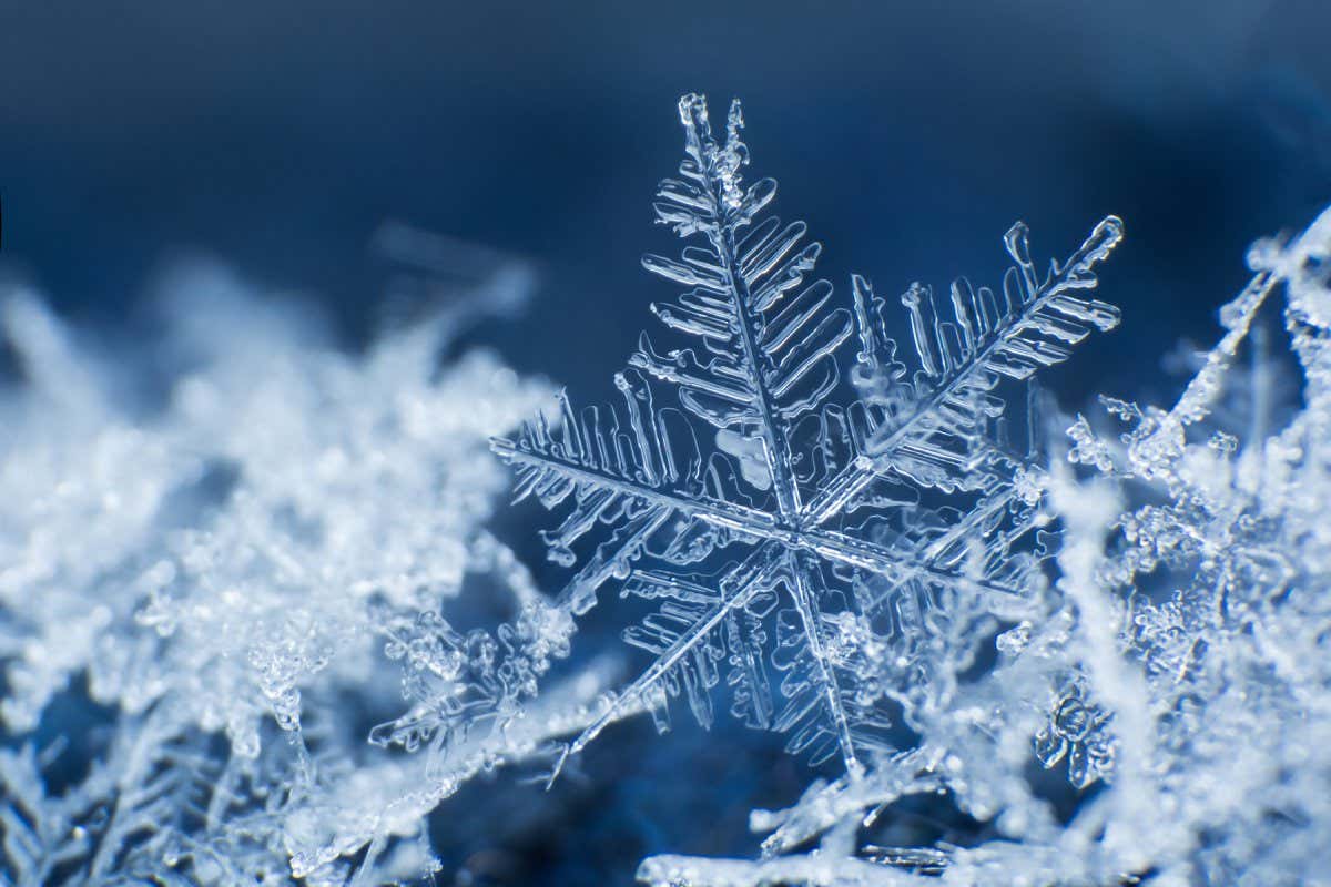 Snowflake on a blue background ; Shutterstock ID 767450926; purchase_order: 04/12/21; job: 18th Dec 21 ; client: NS; other: