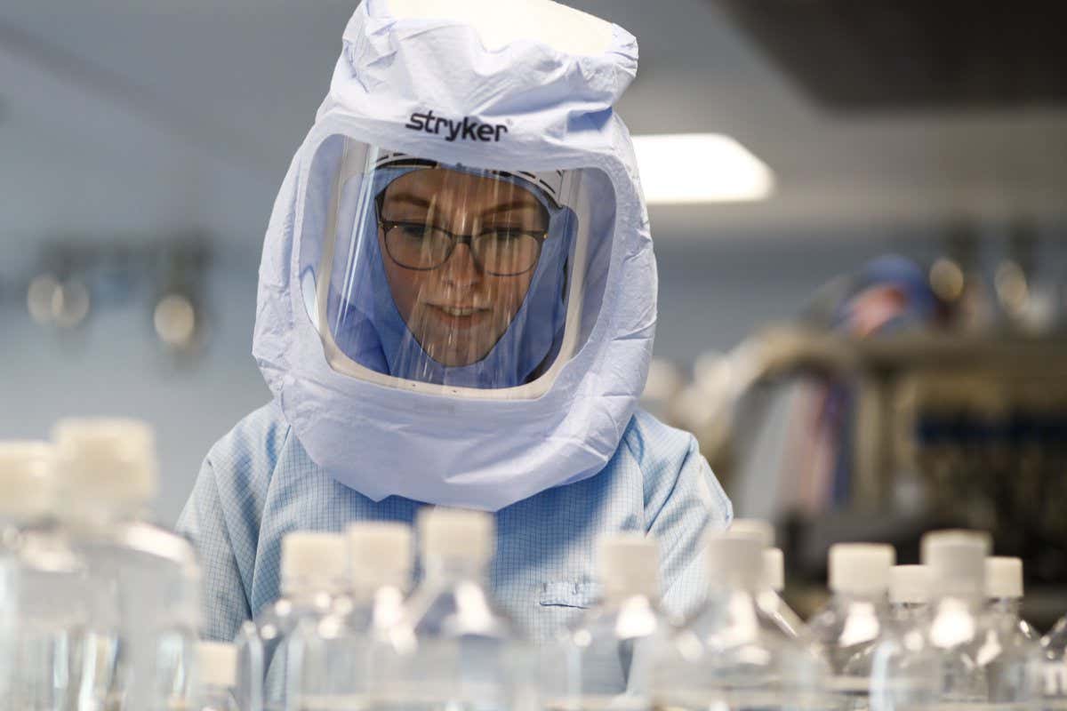 MARBURG, GERMANY - MARCH 29: Employees in special suits test the procedures for the manufacturing of the messenger RNA (mRNA) for the Covid-19 vaccine in German company BioNTech, in Marburg, Germany on March 29, 2021. BioNTech Marburg's coronavirus vaccine production target will be 2.5 billion doses for 2021, up from 2.3 billion as it is considered as one of the largest manufacturing facilities producing mRNA vaccines in the world. The Pfizer-BioNTech vaccine was developed by Ozlem Tureci and Ugur Sahin, a couple who are children of Turkish immigrants in Germany. (Photo by Abdulhamid Hosbas/Anadolu Agency via Getty Images)