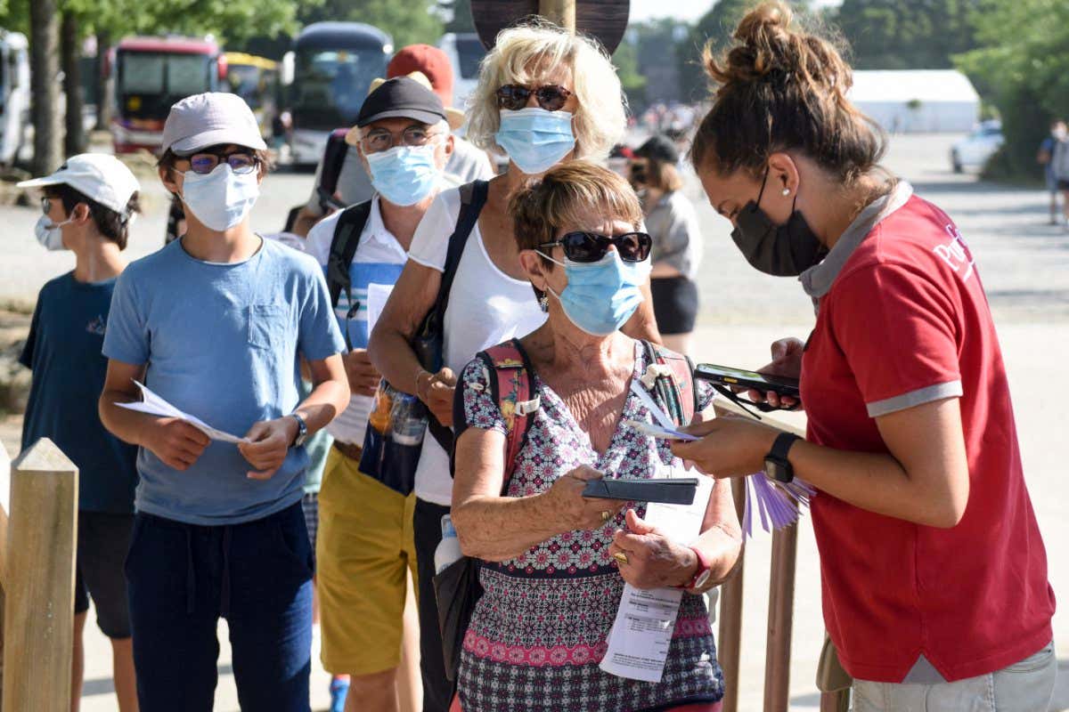 Theme park visitors show their covid passes in France, July 2021