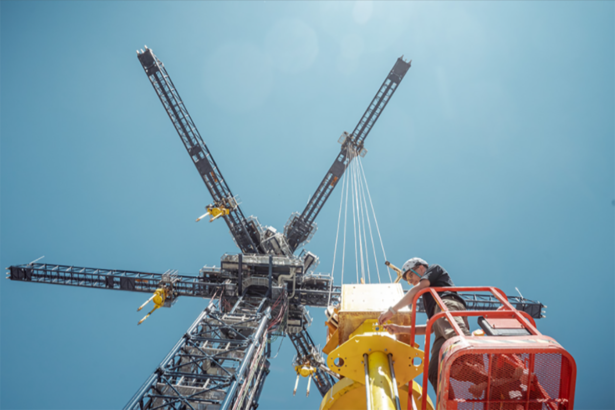 A crane lifts a weight for energy storage