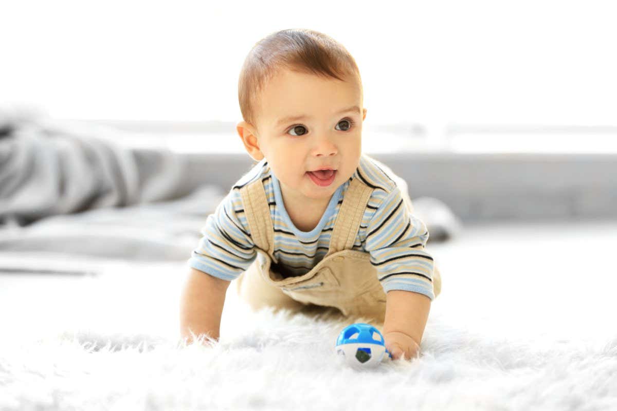 Little baby boy with a toy crawling on the floor at home; Shutterstock ID 407197099; purchase_order: -; job: -; client: -; other: -