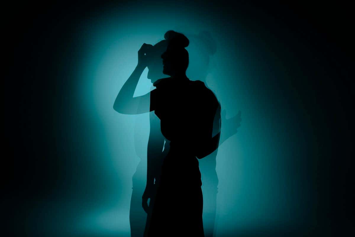 siloette double exposure of young woman expressing multiple emotions, happiness and sorrow