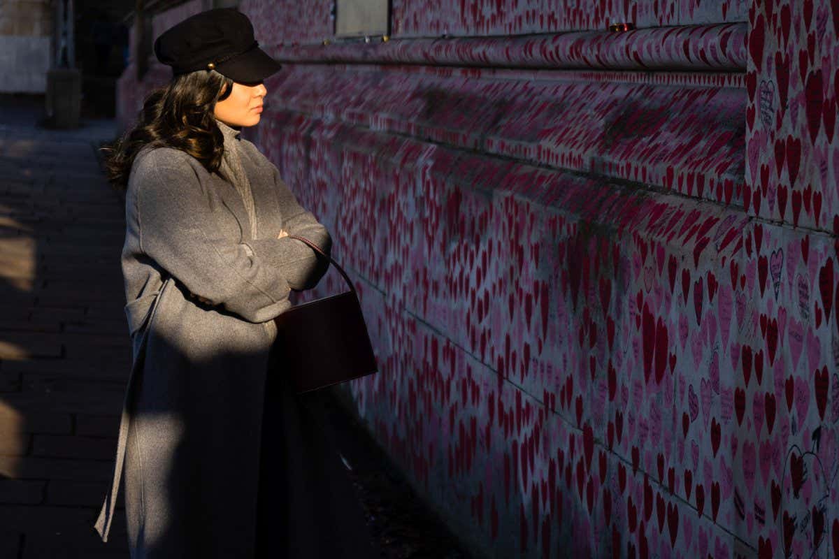 A woman looks at the National Covid Memorial Wall in London