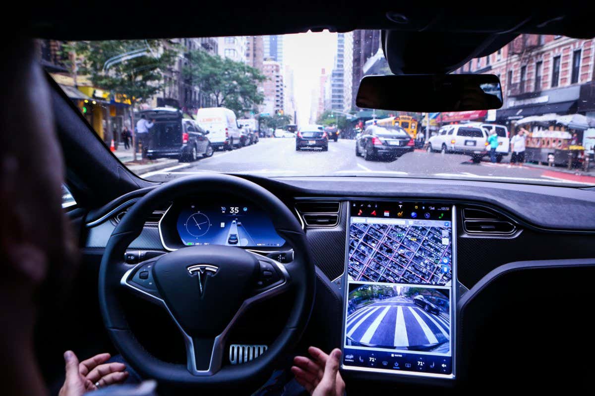 A driver rides hands-free in a Tesla Motors Inc. Model S vehicle equipped with Autopilot hardware and software in New York, U.S. on Monday, Sept. 19, 2016. The latest overhaul of the car's operating system, known as Tesla 8.0, biggest change is how Autopilot shifts towards a heavier reliance on its radar than its camera to guide the car through traffic. Photographer: Christopher Goodney/Bloomberg via Getty Images