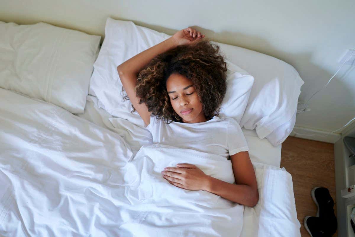Spain, Andalucia, Jerez, Woman sleeping in bed, view from above.