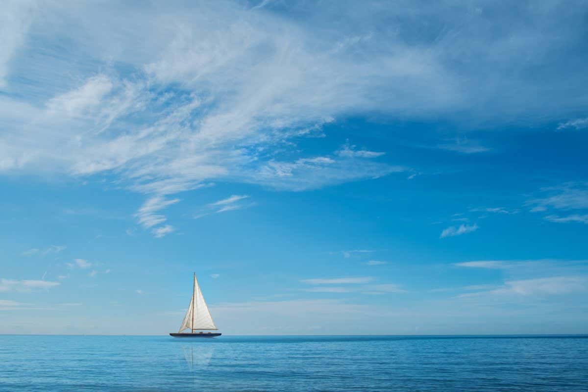 Yacht on horizon at sea with blue sky and clouds; Shutterstock ID 570668743; purchase_order: -; job: -; client: -; other: -