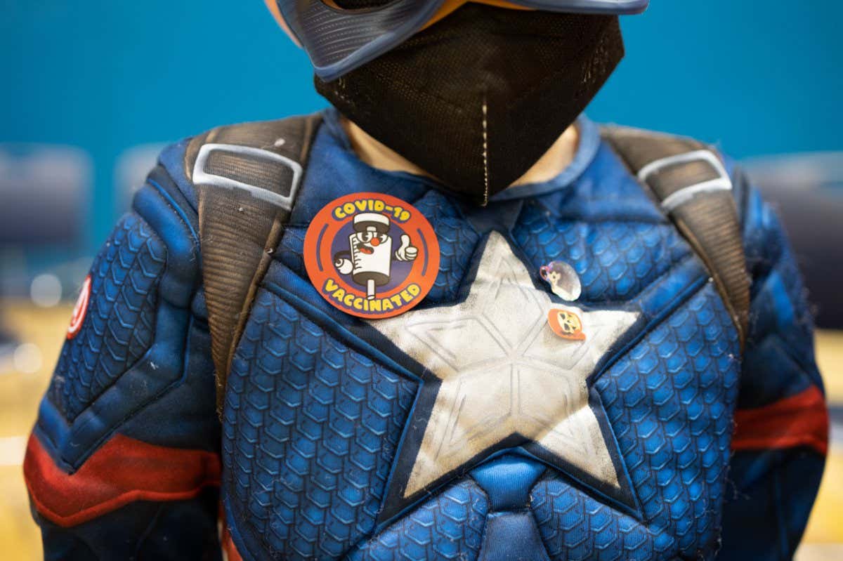 A child waits after receiving a dose of the Pfizer-BioNTech Covid-19 vaccine at a high school in Lansdale, Pennsylvania, U.S. Younger children, ages 5 to 11-year-old, across the U.S. are now eligible to receive Pfizer Inc.'s Covid-19 vaccine, after the head of the Centers for Disease Control and Prevention granted the final clearance needed for shots to begin. Photographer: Hannah Beier/Bloomberg via Getty Images