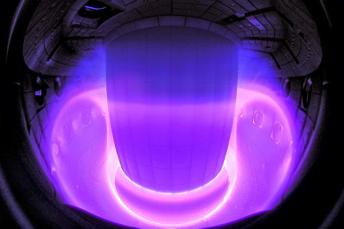 Description: Camera image of a plasma inside the TCV tokamak, regions of different colors correspond to different temperatures of the hot plasma. The center of the plasma is so hot that it does not emit visible light. Credit: Curdin W?thrich / SPC/EPFL