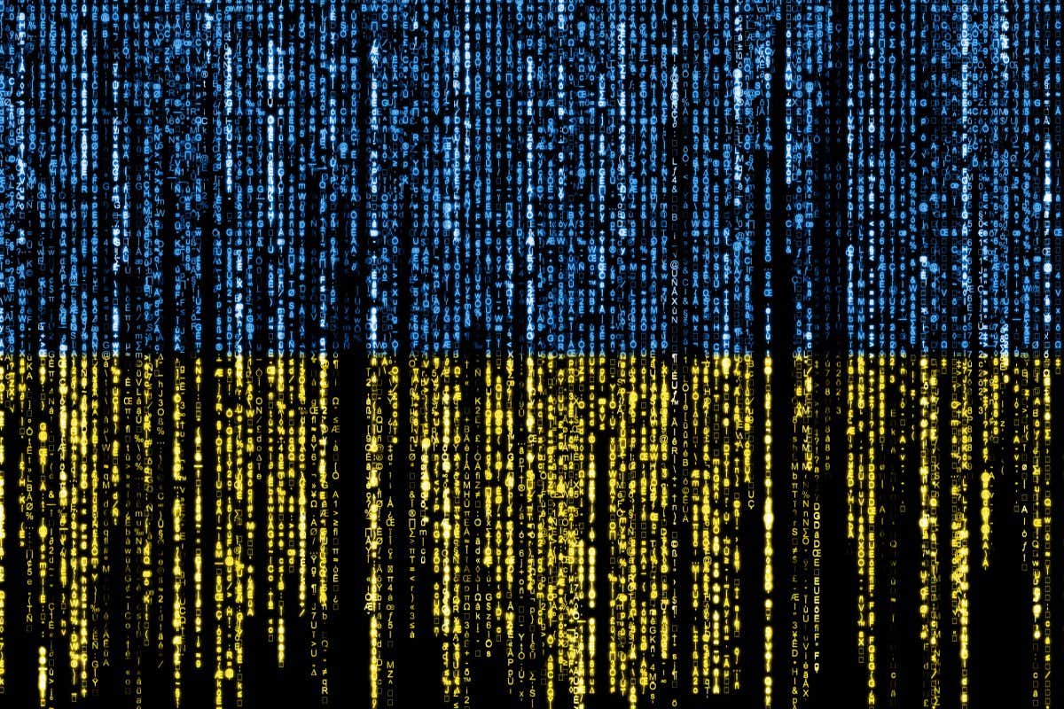 Flag of Ukraine on a computer binary codes falling from the top and fading away.