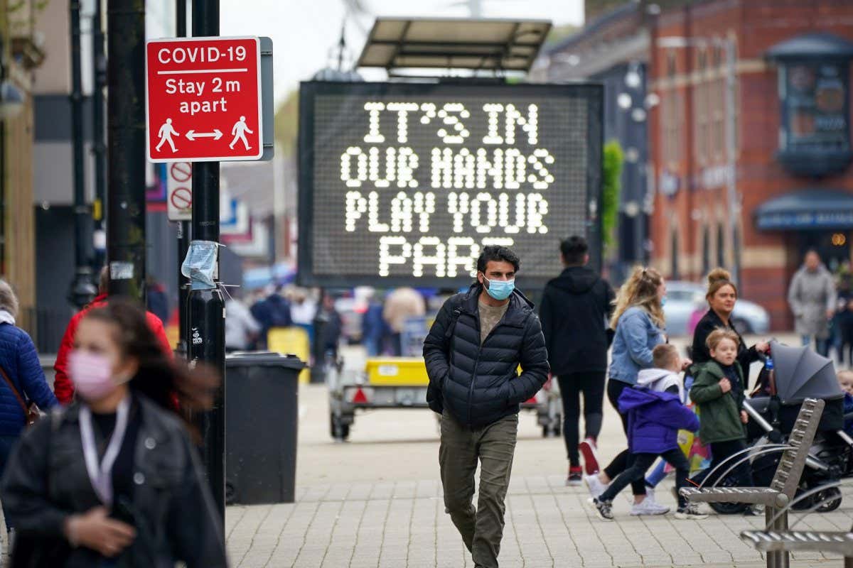 BOLTON, ENGLAND - MAY 26: People shop and go about their daily life in Bolton town centre as surge testing and rapid coronavirus vaccinations continue on May 26, 2021 in Bolton, England. The UK government amended earlier advice asking people to avoid non-essential travel to and from Bolton and seven other places in England experiencing spikes in Covid-19 cases. New guidance asks that people minimise travel to such places, whose local authorities were largely surprised by the initial rule change, published without fanfare on a government website on May 14. (Photo by Christopher Furlong/Getty Images)